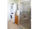 Stackable washer and dryer in laundry room with shower at 3200 Citrus Ct, Lake Wales, FL 33898