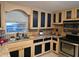 Galley kitchen with granite countertops and wood cabinets at 2031 Poe St, Lakeland, FL 33801