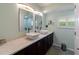 Elegant bathroom with double sinks and modern light fixtures at 1001 Tequesta Trl, Lake Wales, FL 33898