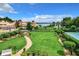 Expansive backyard with a lush lawn, brick path and lake view at 4 Casarena Ct, Winter Haven, FL 33881