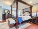 Main bedroom with a large four-poster bed and plenty of closet space at 4 Casarena Ct, Winter Haven, FL 33881