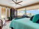 Bright bedroom with large windows, teal bedding, and a view at 4 Casarena Ct, Winter Haven, FL 33881