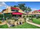 Landscaped backyard with a brick pathway and various potted plants at 4 Casarena Ct, Winter Haven, FL 33881