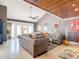 Open living room with gray sofas, wood-beamed ceiling, and access to the patio at 4 Casarena Ct, Winter Haven, FL 33881