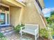 Inviting front porch with a white bench and well-manicured landscaping at 4 Casarena Ct, Winter Haven, FL 33881