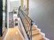 Elegant staircase with wrought iron railing and wood steps at 4 Casarena Ct, Winter Haven, FL 33881
