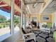 Sunroom with white wicker furniture and access to a patio at 4 Casarena Ct, Winter Haven, FL 33881