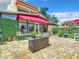 Outdoor patio with brick pavers,lush landscaping, and a built-in grill station at 4 Casarena Ct, Winter Haven, FL 33881