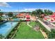 Aerial view showing home, pool, tennis court, and surrounding community at 4 Casarena Ct, Winter Haven, FL 33881