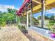 Brick patio with grill and lush landscaping at 4 Casarena Ct, Winter Haven, FL 33881