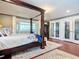 Main bedroom with a large four-poster bed and private access to a balcony at 4 Casarena Ct, Winter Haven, FL 33881