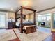 Luxurious main bedroom with a large four-poster bed and access to a private balcony at 4 Casarena Ct, Winter Haven, FL 33881