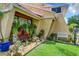 Landscaped area with rocks, plants, and a white bench near the house at 4 Casarena Ct, Winter Haven, FL 33881