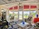 Bright sunroom with water views, wicker furniture, and a wood ceiling at 4 Casarena Ct, Winter Haven, FL 33881
