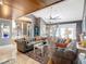 Open living room with gray sofas, wood-beamed ceiling, and access to the patio at 4 Casarena Ct, Winter Haven, FL 33881