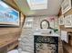 Charming bathroom with stone wall and vessel sink at 4 Casarena Ct, Winter Haven, FL 33881