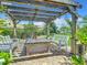 Pergola with seating area and wooden table, perfect for outdoor dining at 4 Casarena Ct, Winter Haven, FL 33881