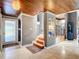 Bright and spacious entryway with wood stairs and tile floor at 4 Casarena Ct, Winter Haven, FL 33881