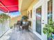 Relaxing balcony with patio furniture and red awning at 4 Casarena Ct, Winter Haven, FL 33881