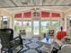 Bright sunroom with water views, wicker furniture, and a wood ceiling at 4 Casarena Ct, Winter Haven, FL 33881