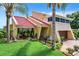 Exterior of house with red tile roof, landscaping, and palm trees at 4 Casarena Ct, Winter Haven, FL 33881