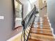 Modern staircase featuring a wrought iron railing and wood steps at 4 Casarena Ct, Winter Haven, FL 33881