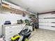 Organized garage with workbench, storage, and lawnmower at 4 Casarena Ct, Winter Haven, FL 33881