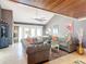 Spacious living room with gray sofas, wood-beamed ceiling, and a cozy fireplace at 4 Casarena Ct, Winter Haven, FL 33881