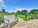 White bench overlooking a beautifully landscaped backyard with a pond at 4 Casarena Ct, Winter Haven, FL 33881
