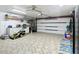 Large garage with overhead storage and workshop area at 4 Casarena Ct, Winter Haven, FL 33881