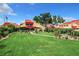 Spacious backyard with lush lawn, landscaping, and a relaxing patio area at 4 Casarena Ct, Winter Haven, FL 33881