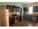 Modern kitchen featuring dark brown cabinets, stainless steel appliances, and granite countertops at 4850 St James Ct, Winter Haven, FL 33881