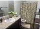 Clean bathroom with a shower/tub combo, vanity, and a neutral color palette at 4850 St James Ct, Winter Haven, FL 33881