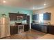 Modern kitchen featuring dark brown cabinets, stainless steel appliances, and granite countertops at 4850 St James Ct, Winter Haven, FL 33881