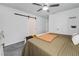 Main bedroom with a king-size bed, barn door, and ceiling fan at 339 Lake Smart Cir, Winter Haven, FL 33881
