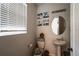 Clean bathroom with pedestal sink, toilet, and window at 339 Lake Smart Cir, Winter Haven, FL 33881