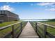 Wooden boardwalk with lake view and house at 339 Lake Smart Cir, Winter Haven, FL 33881