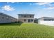 Two-story house back view, showcasing a spacious backyard at 339 Lake Smart Cir, Winter Haven, FL 33881