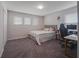 Bright bedroom with a queen-size bed, workspace, and gray carpet at 339 Lake Smart Cir, Winter Haven, FL 33881