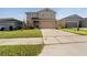 Two-story house with a two-car garage and a well-maintained lawn at 339 Lake Smart Cir, Winter Haven, FL 33881