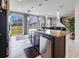 Modern kitchen with granite island, stainless steel appliances, and backyard access at 339 Lake Smart Cir, Winter Haven, FL 33881