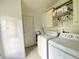 Bright laundry room with washer, dryer and storage at 2010 Ridge Meadow Dr, Lakeland, FL 33809