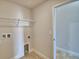 Bright laundry room with shelving and access to another room at 1222 Tagliamento Ln, Haines City, FL 33844