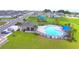 Community pool with a clubhouse, playground, and ample lounge space at 506 Tanaro Ln, Haines City, FL 33844