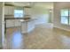 Open kitchen with island, white cabinets, and tile floors at 506 Tanaro Ln, Haines City, FL 33844