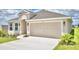 Two-car garage and neutral-colored exterior at 506 Tanaro Ln, Haines City, FL 33844