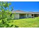 Home with covered patio and grassy backyard at 1218 Tagliamento Ln, Haines City, FL 33844