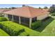 Rear view of a house with a screened lanai and lush landscaping at 4496 Strathmore Dr, Lake Wales, FL 33859