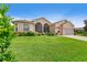 Single-story home with a well-manicured lawn and attached garage at 4496 Strathmore Dr, Lake Wales, FL 33859