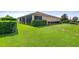 Side view of house with well-manicured lawn and hedges at 4496 Strathmore Dr, Lake Wales, FL 33859